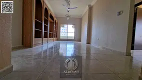 Two-bedroom apartment with a spacious living room for annual rent, including parking and gym access,