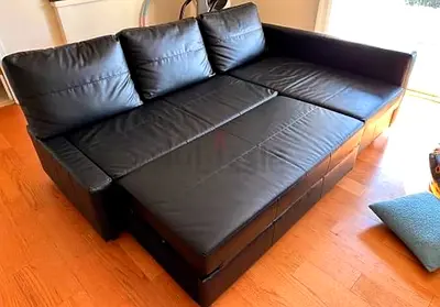 Black leather 3-seater sofa bed with storage - excellent condition