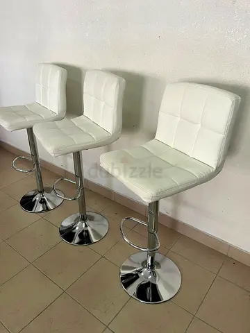 White bar stools with upholstered backrests