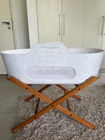 SnuzBaskit Portable baby bassinet with wooden stand (used)