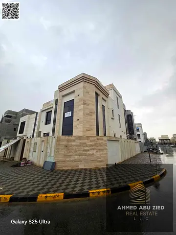 Corner villa for sale in Al Zahia, Ajman, in a prime location close to all services and main roads. Features include 7 master bedrooms, 9 bathrooms, 2