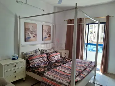 Elegant Four-Poster Bed with nightstands and dresser