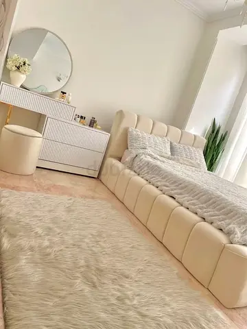 Beige Upholstered Platform Bed with Dresser and Faux Fur Rug -