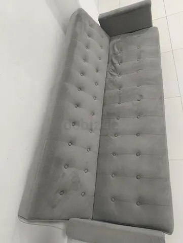 Gray tufted 3-seater sofa bed in good condition
