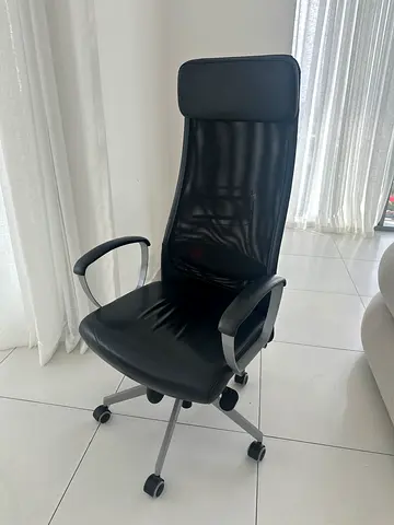 Black ergonomic office chair with mesh back and armrests