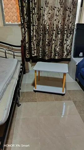 Small white bedside table with wheels