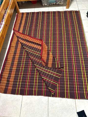Handwoven striped floor rug — brown, red and yellow — good condition