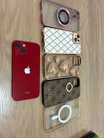 iPhone 13 (Red) with 5 Designer Cases - Good Condition