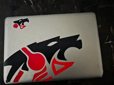 Used Silver Laptop with Decorative Stickers - Good Working Condition