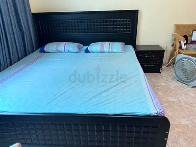 King Size Black Wooden Bed Frame with Headboard along with One Bed table
