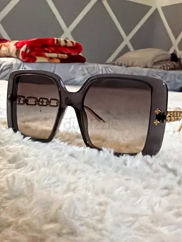 Black oversized womens sunglasses with gold chain detail