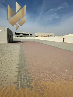 Prime yard in Al Sajaa on a main road, 28,000 sq. ft., with offices and suitable power, ready for op