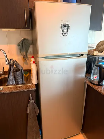 Silver double-door refrigerator in good working condition