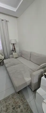 Light grey L-shaped fabric sofa bed — good condition, just needs cleaning.