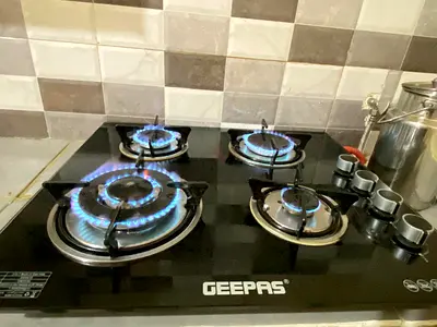 Urgent 4-Burner Glass Top Gas Stove - Good Working Condition includes cylinder and pipe with Regulat