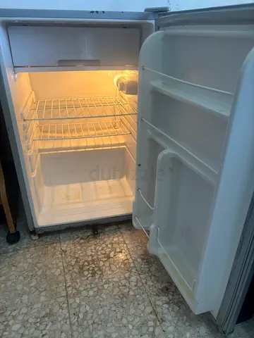 Compact single-door mini fridge in working condition