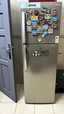 Silver double-door refrigerator (top freezer) in working condition