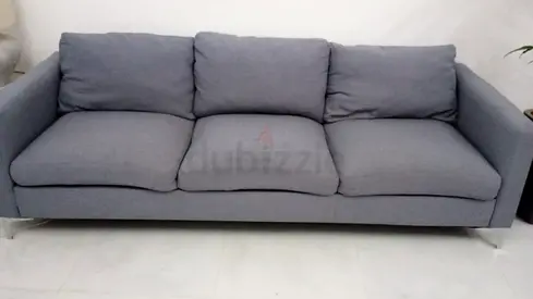 Three-seater grey fabric sofa in good used condition