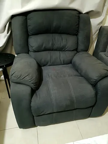 Gently used dark grey single recliner armchair