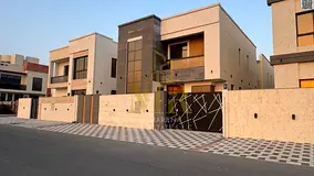 Own a modern villa for sale in Al Yasmin area, Ajman, at a price that includes registration and owne