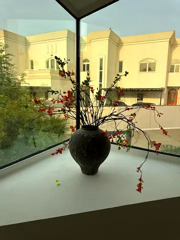 Decorative ceramic vase with faux floral arrangement