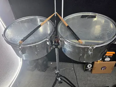Pair of metal timbales with stand and sticks - used