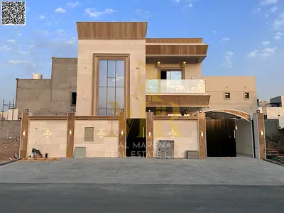 Two-story villa in Ajman, including electricity, water, and air conditioning, with freehold ownership available to all nationalities.