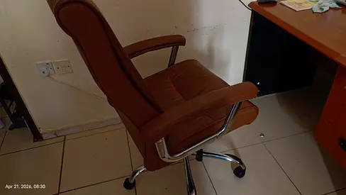 Brown leather swivel office chair with armrests — good condition