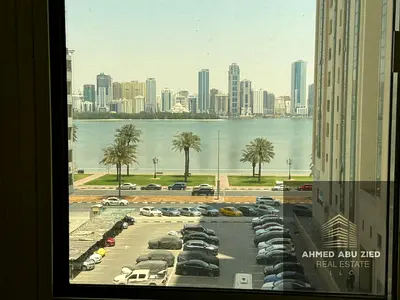 The most luxurious and beautiful three-bedroom apartment with a living room and maid's room in Sharjah, Al Majaz 3 area, with a direct view of the lak
