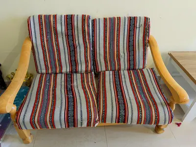 Two-seater wooden sofa with striped upholstery