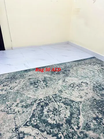 Used green patterned area rug - good condition, 50 AED