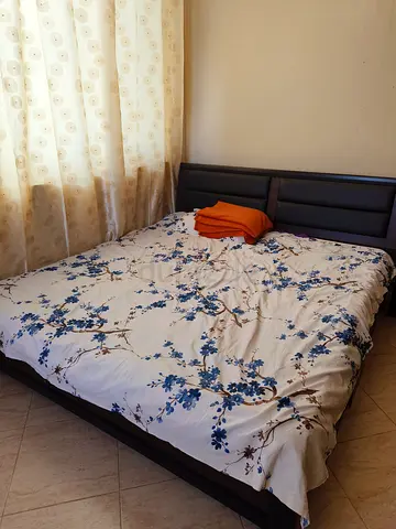 King size bed and mattress with side table for sale in RAK