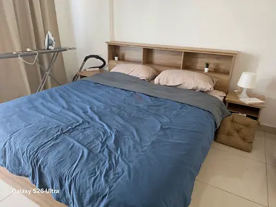 Queen size bed frame with built-in headboard shelving and mattress - light wood