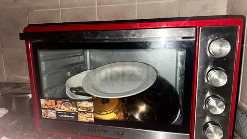 Used Red Oster countertop oven in working condition