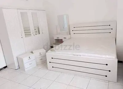 White bedroom set: bed, wardrobe, dresser and bedside units