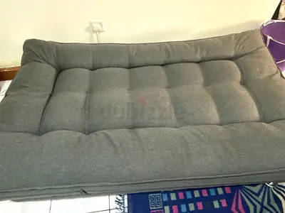 Comfortable grey sofa bed in good condition. Perfect for studio apartments or guests.