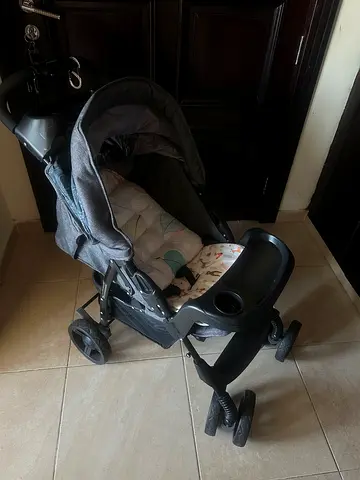 Lightly used gray standard baby stroller with reclining seat and free cushion worth 99AED.