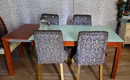 Wooden Dining Table with Glass top . Extendable to 6-8 seats .4 Upholstered Chairs - sofa.
