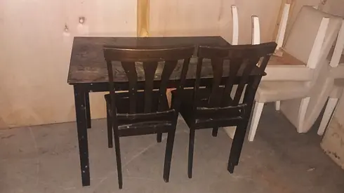Used dark wood dining table with two matching chairs