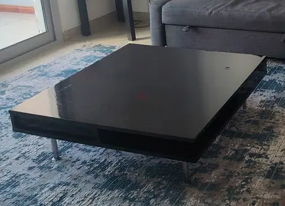 Low black modern coffee table with metal legs