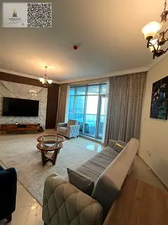 For annual rent in Ajman, Corniche Residence Towers, sea and city view, two-bedroom apartment with a
