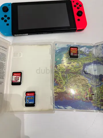 Nintendo Switch console with 3 game cartridges (red/blue Joy-Con) - good condition