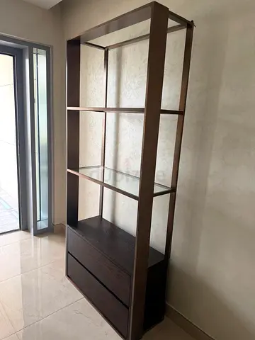 Tall dark wood shelving unit with drawers — good condition