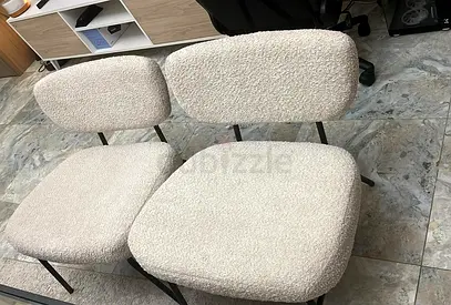 Pair of beige boucle accent chairs with black metal legs - good condition