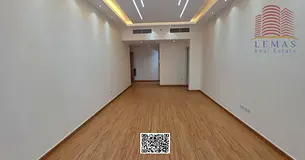 One bedroom and living room with a garden view and a closed kitchen.