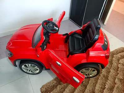 Red Electric Ride-On Car for Kids with Steering Wheel and Dashboard