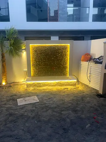 Outdoor decorative LED water feature with stone panel grass