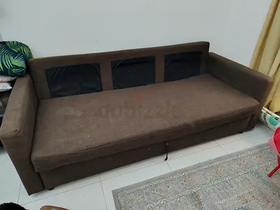Brown three-seater sofa with storage, used