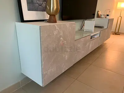 Modern wall-mounted TV entertainment unit with marble finish
