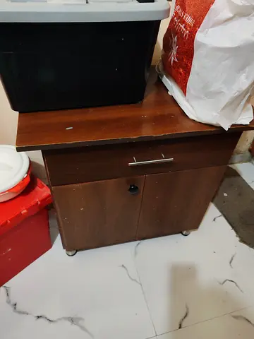 Small wooden storage cabinet with drawer and lockable doors